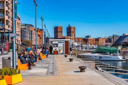 OSLO, NORWAY, APRIL 15, 2019: Town hall in oslo viewed behind Stranden waterfront, Norwayの写真素材