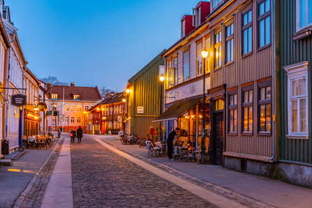 TRONDHEIM, NORWAY, APRIL 15, 2019: Sunset view of a narrow street in the Brygge district of Trondheim, Norwayの写真素材