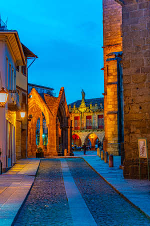 GUIMARAES, PORTUGAL, MAY 23, 2019: Sunset view of people strolling over Largo da Oliveria in the old town of Guimaraes, Portugalのeditorial素材