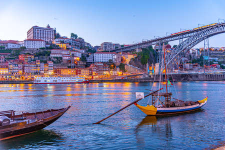 PORTO, PORTUGAL, MAY 25, 2019: Sunset view of Rabelo boats mooring at Porto, Portugalのeditorial素材