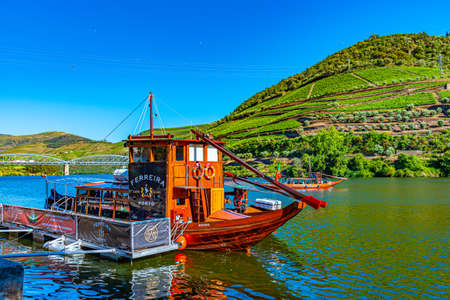 PINHAO, PORTUGAL, MAY 26, 2019: Cruise ship on Douro river passing among vineyards, Portoのeditorial素材