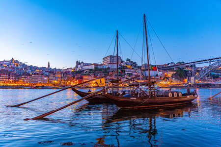 PORTO, PORTUGAL, MAY 25, 2019: Sunset view of Rabelo boats mooring at Porto, Portugalのeditorial素材