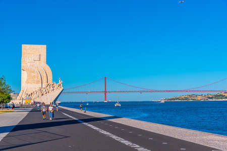 LISBON, PORTUGAL, MAY 29, 2019: People are admiring PadrÃ£o dos Descobrimentos - Monument of the Discoveries, Bridge of 25th April and National sanctuary of Cristo Rei in Lisbon, Portugalのeditorial素材