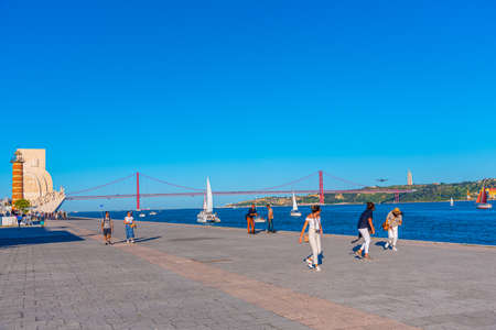 LISBON, PORTUGAL, MAY 29, 2019: People are admiring PadrÃ£o dos Descobrimentos - Monument of the Discoveries, Bridge of 25th April and National sanctuary of Cristo Rei in Lisbon, Portugalのeditorial素材