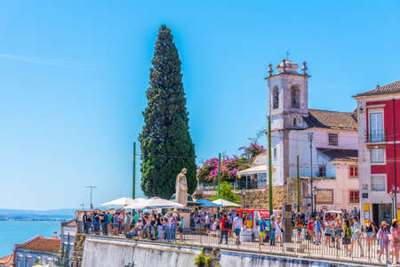 LISBON, PORTUGAL, JUNE 1, 2019: People are admiring Alfama district in Lisbon from Santa Luzia viewpoint, Portugalのeditorial素材