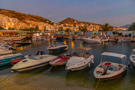 Sunset view of boats mooring alongside seaside promenade at Sarande, Albaniaの写真素材