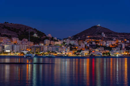 Sunset view of seaside of Sarande with Lekuresi castle, Albania