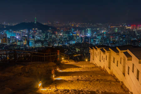 Namsan tower viewed behind an ancient wall at Inwangsan mountain in Seoul, Republic of Koreaの写真素材