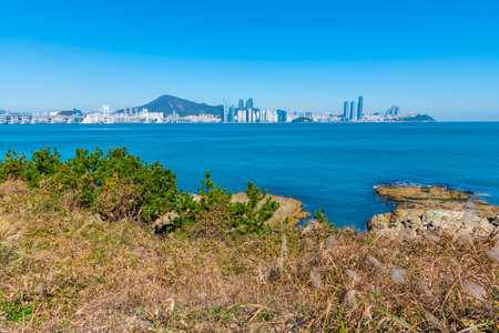 Skyline of Busan viewed behind Igidae peninsula, Republic of Koreaの写真素材