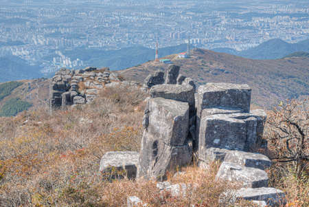 Gwangju viewed behind rocks of Jusangjeolli Cliff at Mudeungsan Mountain, Republic of Korea
