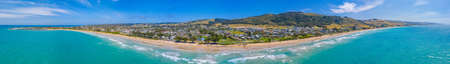 People are enjoying a sunny day on a beach at Apollo Bay, Australia