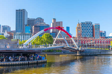 MELBOURNE, AUSTRALIA, JANUARY 1, 2020: Panorama of Melbourne behind Evan walker bridge over Yarra river, Australiaの写真素材