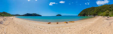Yellow kayaks at Onetahuti beach at Abel Tasman national park in New Zealandの写真素材