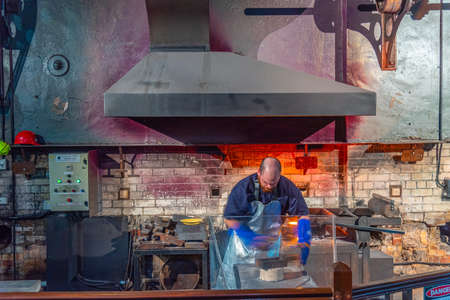 PERTH, AUSTRALIA, JANUARY 18, 2020: show displaying a process of manufacturing a golden bar at Perth mint, Australiaのeditorial素材