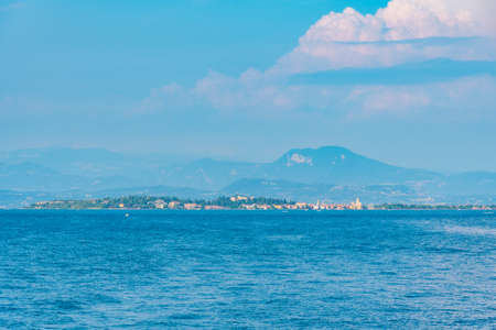 Sirmione town at Lago di Garda viewed from Desenzano del Garda in Italyの写真素材