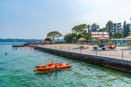 GARDONE RIVIERA, ITALY, JULY 23, 2019: Beach at Gardone Riviera situated at Lago di Garda in Italyのeditorial素材