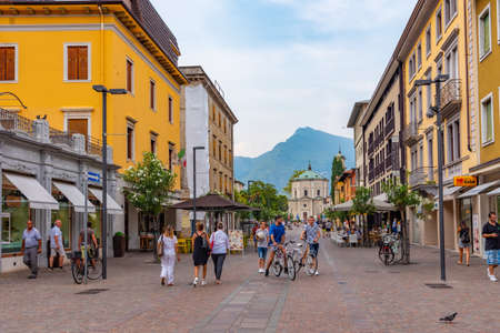 RIVA DEL GARDA, ITALY, JULY 22, 2019: People are strolling thorugh a street in Riva del Garda in Italyのeditorial素材