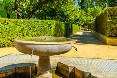 Fountain at gardens of Real Alcazar de Sevilla in Spainの写真素材