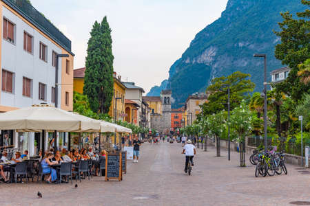 RIVA DEL GARDA, ITALY, JULY 22, 2019: People are passing porta di san michele in Riva del Garda in Italyのeditorial素材
