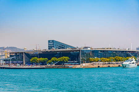 BARCELONA, SPAIN, JUNE 30, 2019: People are passing by in front of Maremagnum shopping center in Barcelona, Spainの写真素材