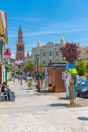 CARMONA, SPAIN, JUNE 24, 2019: White street of Spanish town Carmona and tower of San Bartolome...