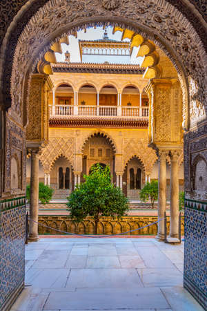 SEVILLA, SPAIN, JUNE 25, 2019: Patio de las Doncellas viewed through ornated gate at real alcazar de Sevilla in Spainのeditorial素材