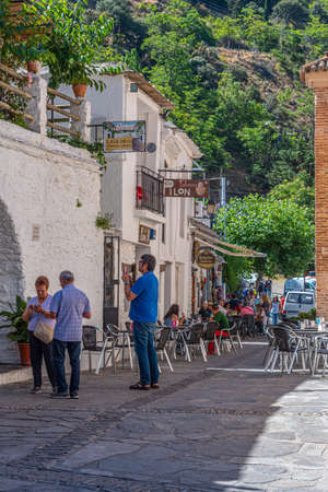 PAMPANEIRA, SPAIN, JUNE 22, 2019: People are stolling on the main street of Pampaneira in Spainのeditorial素材