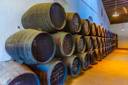 JEREZ DE LA FRONTERA, SPAIN, JUNE 26, 2019: Wine barrels inside of Bodega of Tio Pepe at Jerez de la...