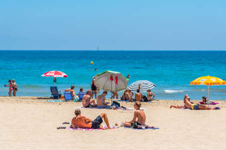 ALICANTE, SPAIN, JUNE 18, 2019: People are enjoying a sunny day on Postiguet beach in Alicante in Spainのeditorial素材