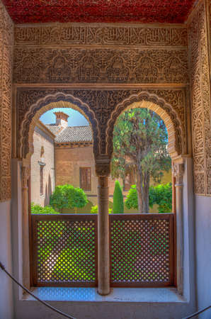 Lindaraja garden viewed through a window at Nasrid palace of Alhambra fortress in Granada, Spainのeditorial素材