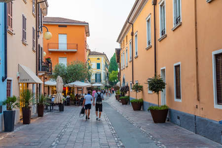 DESENZANO DEL GARDA, ITALY, JULY 23, 2019: People are strolling on a street in Desenzano del Garda in Italyのeditorial素材