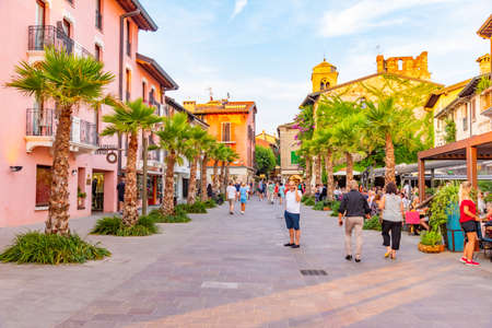 SIRMIONE, ITALY, JULY 21, 2019: People are strolling thorugh a street in Sirmione in Italyのeditorial素材