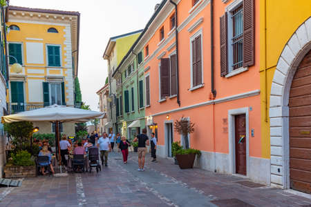 DESENZANO DEL GARDA, ITALY, JULY 23, 2019: People are strolling on a street in Desenzano del Garda in Italyのeditorial素材