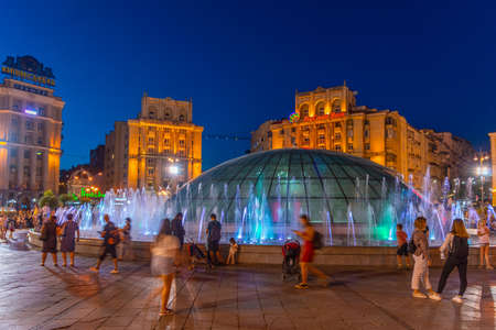 KYIV, UKRAINE, AUGUST 29, 2019: Night view of people passing singing fountain at the independence square in Kyiv, Ukraineのeditorial素材