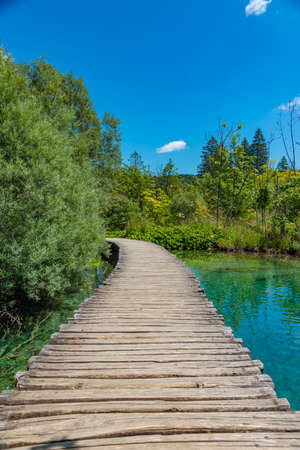 Wooden boardwalk leading through plitvice lakes national park in Croatiaの写真素材