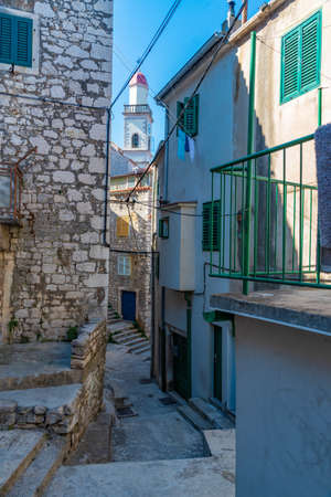 Church tower viewed from a narrow street in Sibenik, Croatiaの写真素材