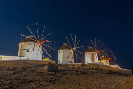 Night view of windmills overlooking aegean sea at Mykonos, Greece