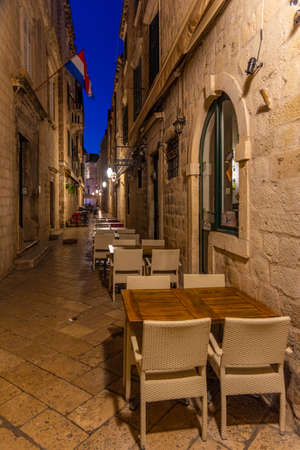 Sunrise view of restaurant tables at a narrow street in the old town of Dubrovnik, Croatiaの写真素材