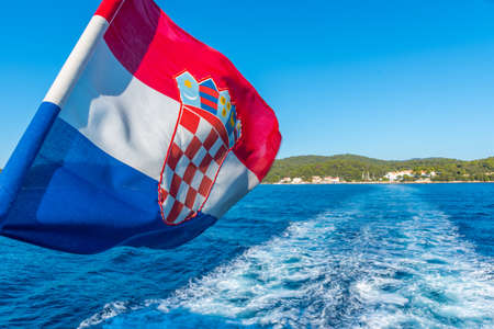 Croatian flag waving from a moving boatの写真素材