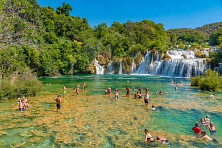 Sibenik, Croatia, July 22, 2020: People swimming at Krka river near Skradinski Buk waterfall, Croatiaのeditorial素材