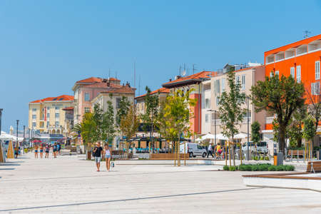Porec, Croatia, July 31, 2020: People are strolling at the waterfront of Porec in Croatia