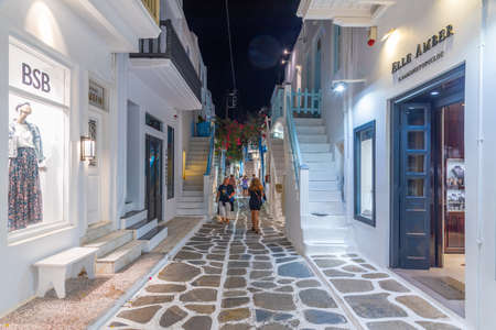 Mykonos, Greece, September 26, 2020: Night view of tourist shops at a narrow street in the old town of Mykonos, Greeceのeditorial素材