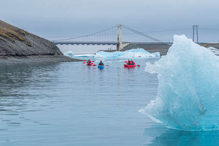 Jokulsarlon, Iceland, August 24, 2020: Kayaking amon icebergs at Jokulsarlon lagoon in Iceland