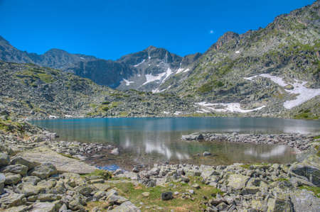 Musala peak mirroring at a surface of a mountain lake in bulgariaの写真素材