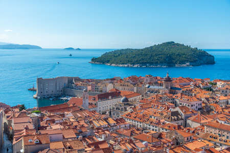 Aerial view of red rooftops of old town of Dubrovnik and Lokrum island, Croatiaの写真素材