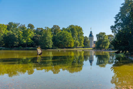 Karlsruhe palace during a sunset viewed from Schlossgarten park in Germanyのeditorial素材