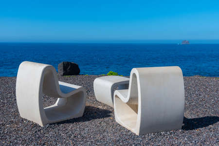 chairs overlooking landscape of El Hierro island at a costal path connecting La Maceta and Punta Grande, Canary islands, Spain.の写真素材