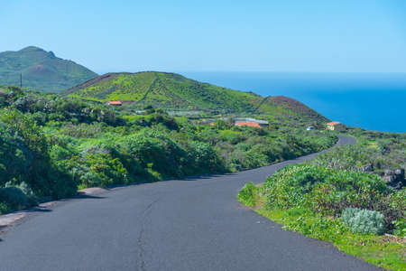 Empty road passing through a volcanic landscape of El Hierro island, Canary islands, Spain.の写真素材