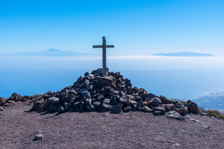 Wooden cross, Tenerife and La Gomera viewed from Pico de la Nieve at La Palma, Canary islands, Spain.の写真素材