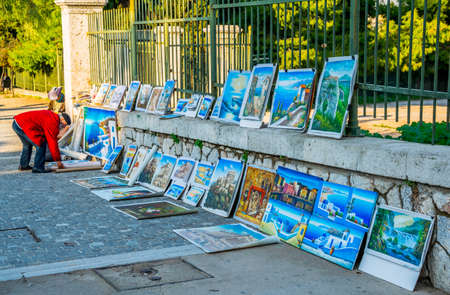 ATHENS, GREECE, DECEMBER 10, 2015: street artist is selling his pictures of greece on the way to akropolis complex in athensのeditorial素材